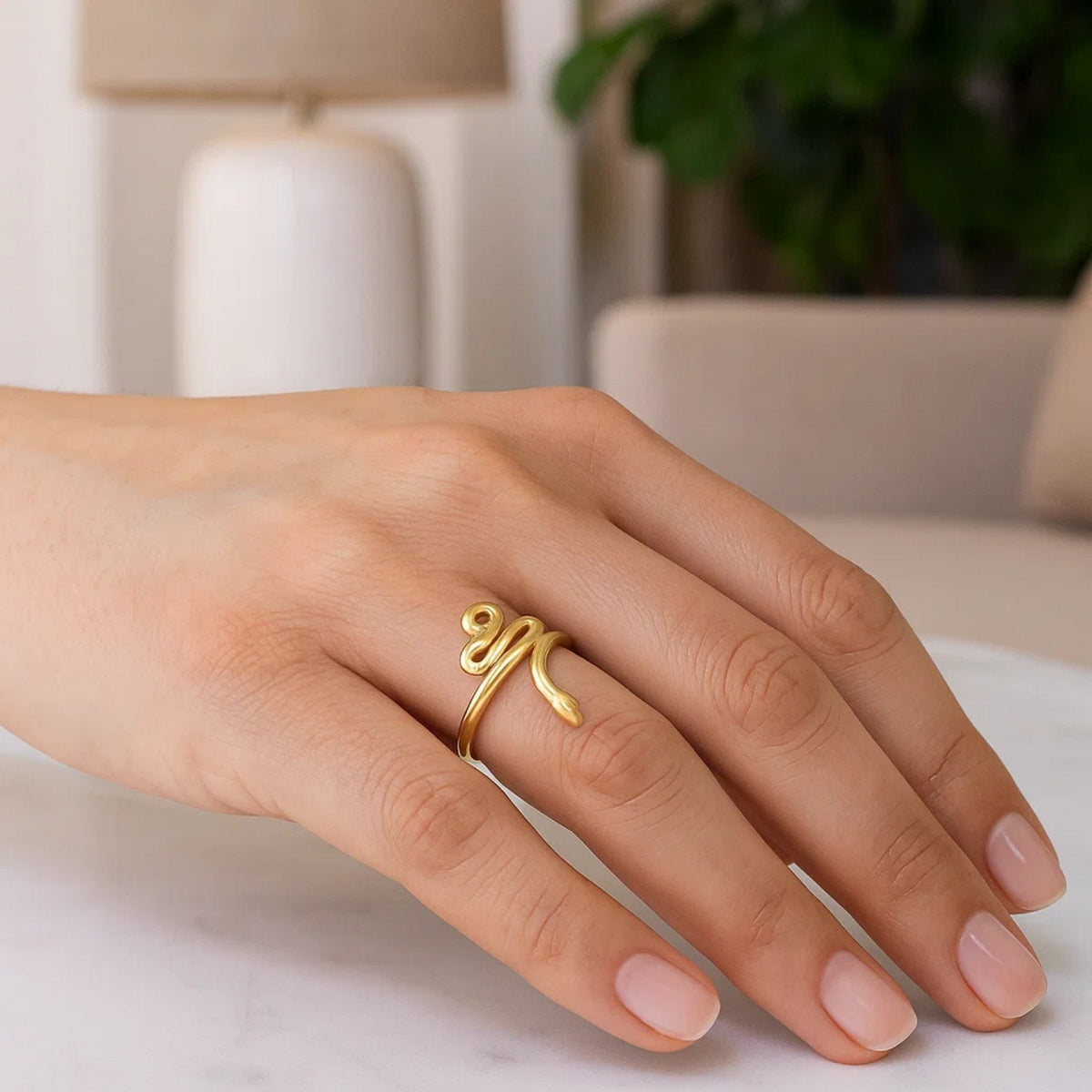 14K yellow gold serpent snake ring worn on finger, lifestyle shot showing scale and fit savannah lane jewelry