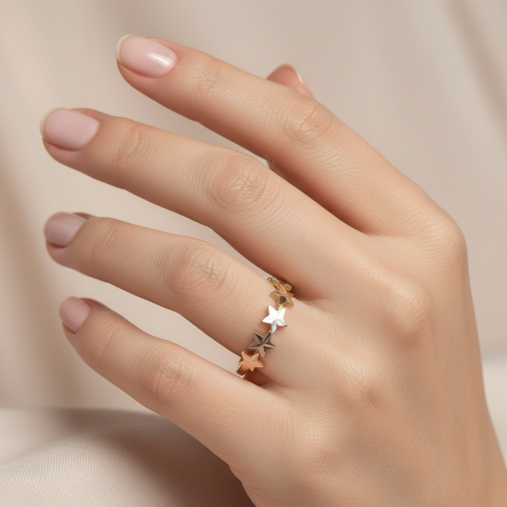Woman wearing 10k tri color gold star band ring on hand