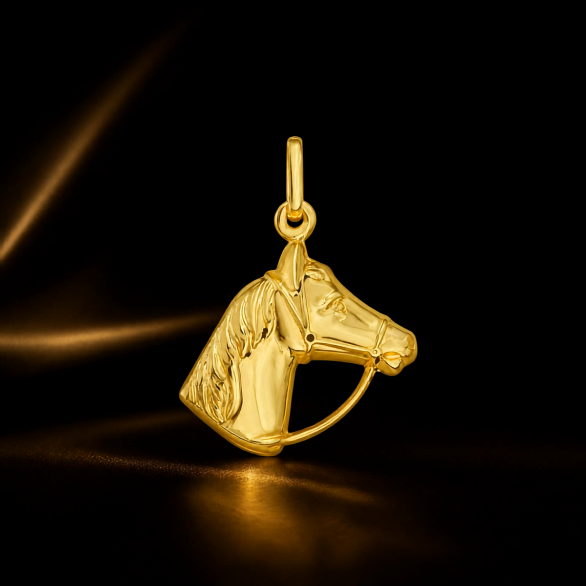 Polished 14K yellow gold horse face charm pendant photographed against a dark background with warm highlights