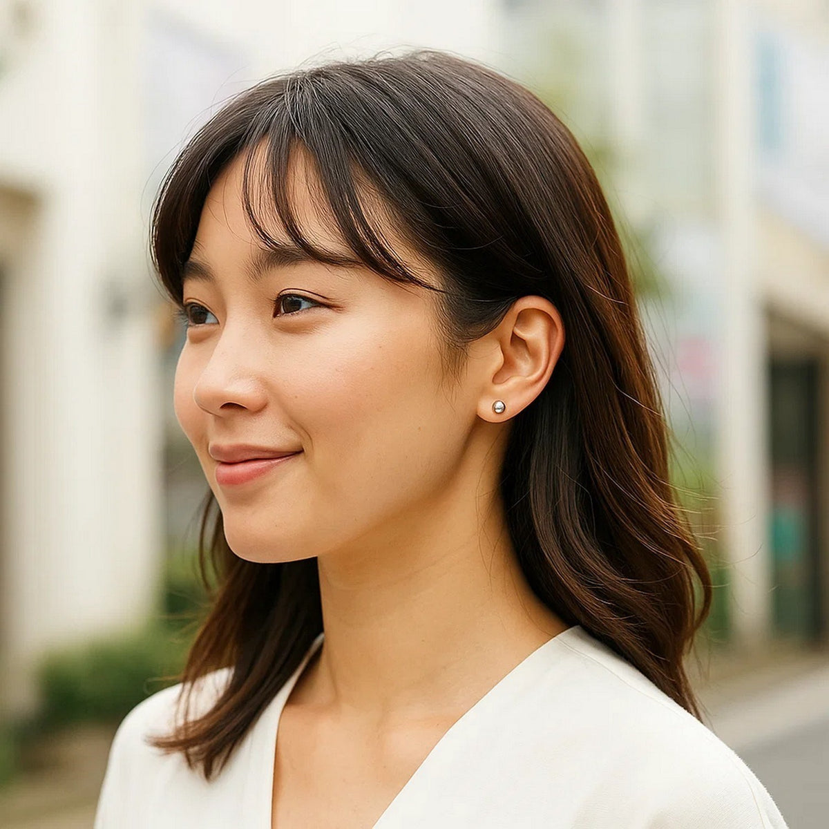 Woman wearing 925 sterling silver 5mm ball stud earrings outdoors lifestyle