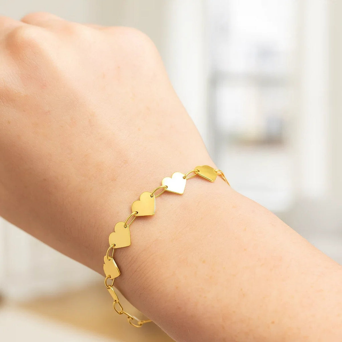 10K Yellow Gold Heart Chain Bracelet worn on wrist, elegant everyday fine jewelry