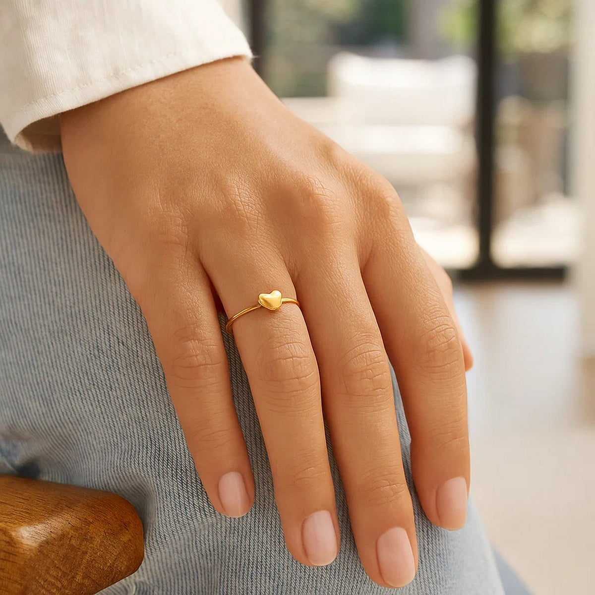 Close-up view of 14k gold puffed heart ring on hand