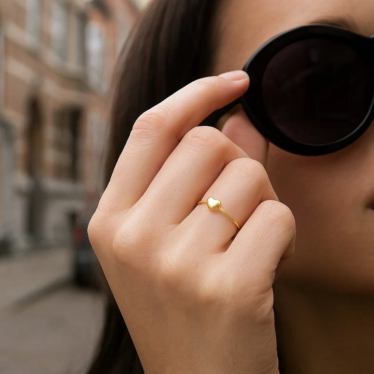 Woman wearing 14k yellow gold puffed heart ring