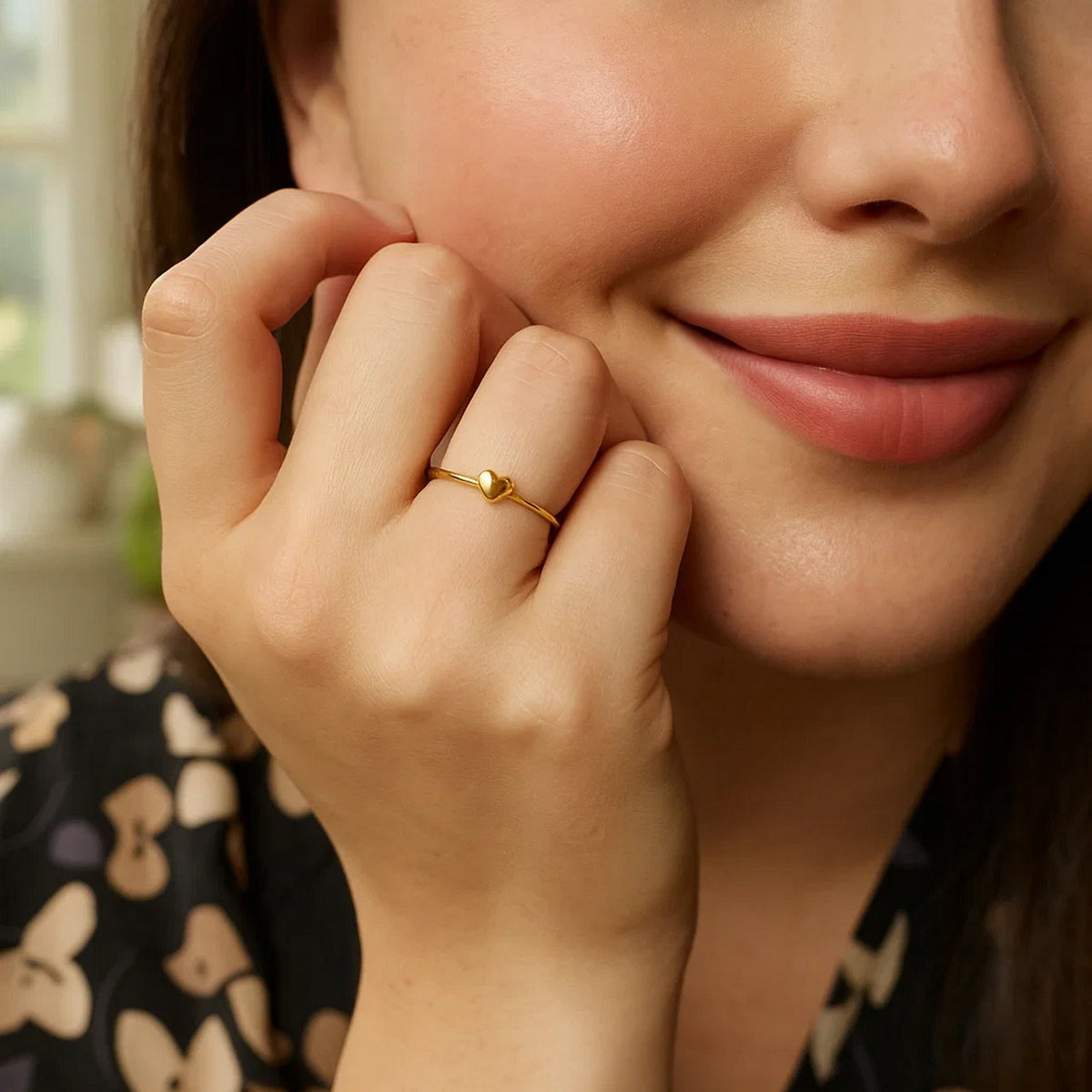 Side angle view of 14k gold puffed heart ring on hand