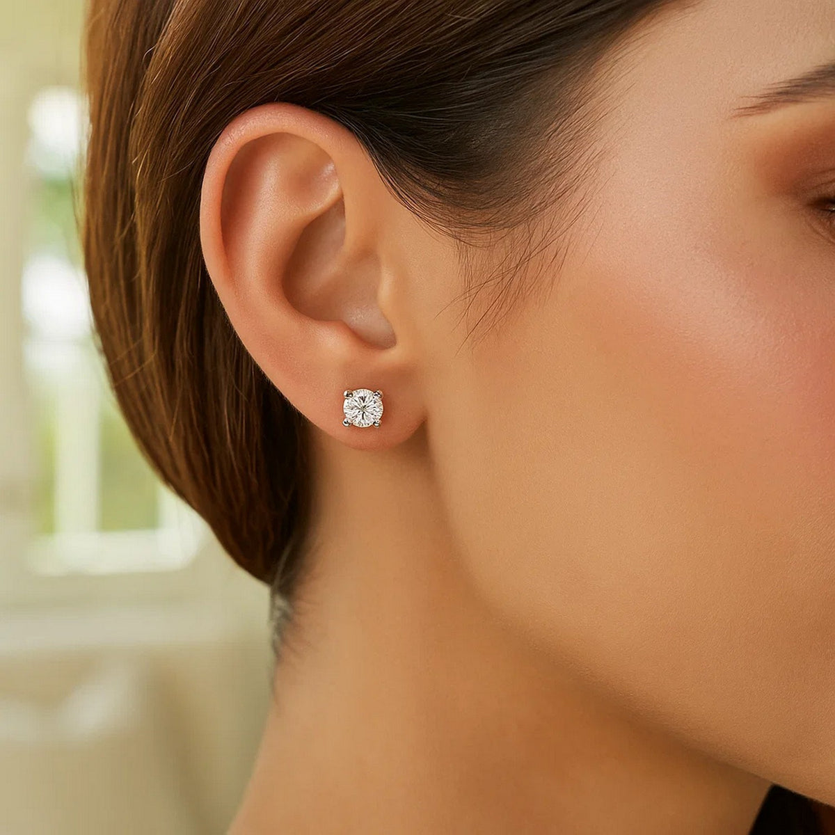 Woman wearing 5mm round CZ stud earrings in 925 sterling silver — gifts for her, fine jewelry