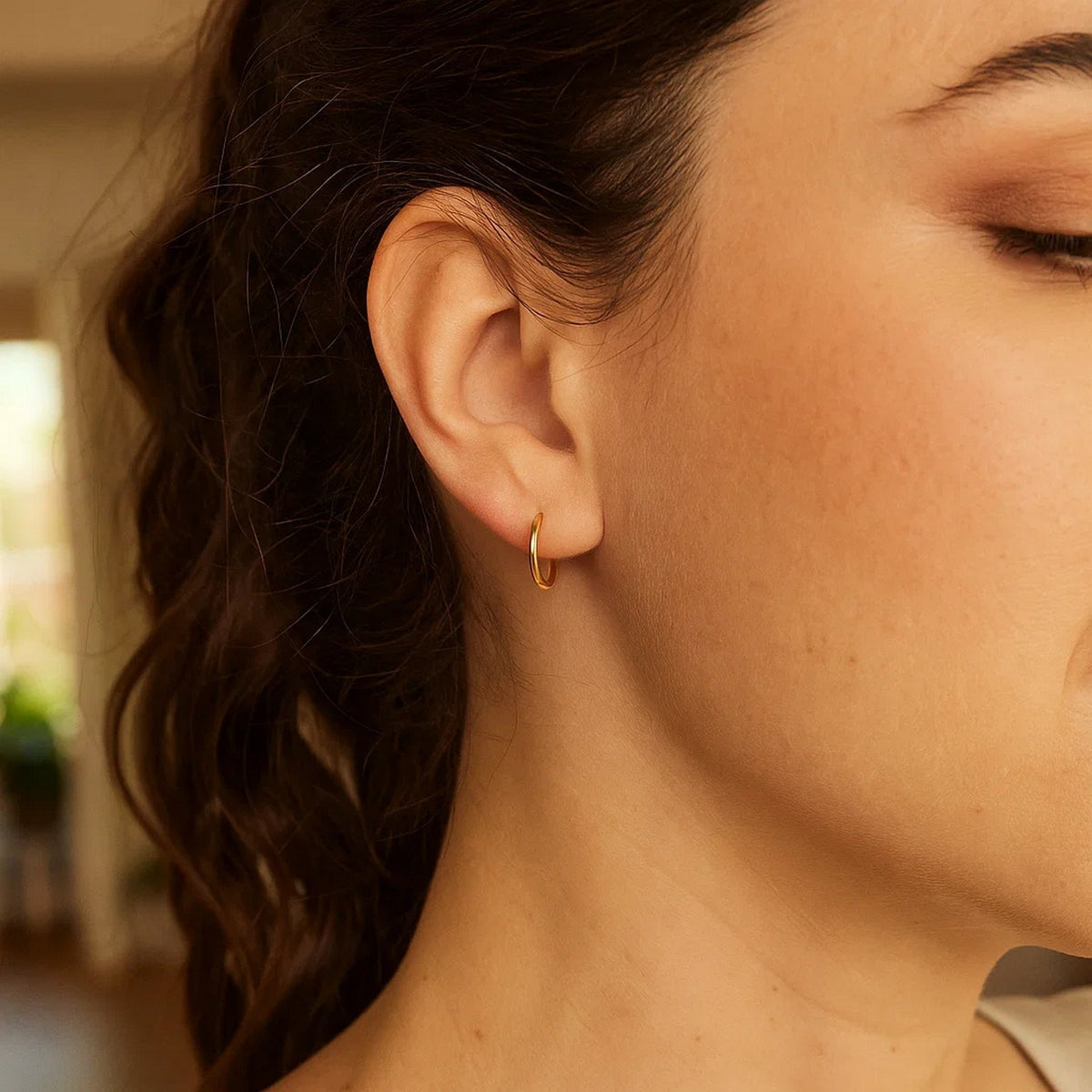 Side profile of woman wearing Savannah Lane Jewelry 10K yellow gold mini endless hoop earrings – small gold hoops, gifts for her